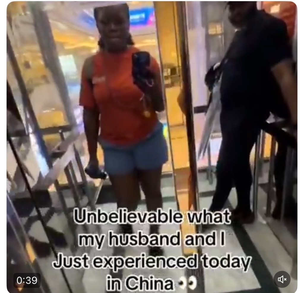 Old chinese women hold their noses as they enter an elevator with black&nbsp;tourists